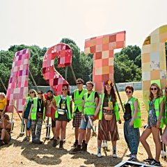 Staff at the Glastonbury sign in 2019.